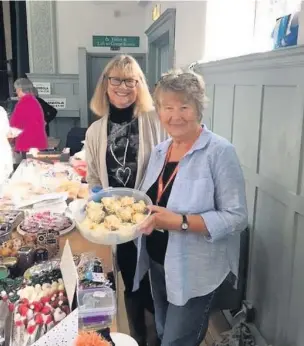  ??  ?? Alison Spencer, front, with fellow volunteer Carol Hyett at a coffee morning fundraiser in Garstang