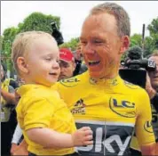  ?? AP ?? Tour de France winner Chris Froome holds his son Kellan after the last stage in Paris on Sunday.