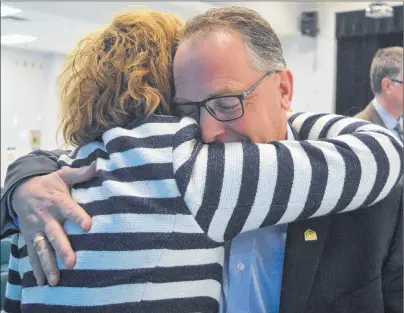  ?? CAPE BRETON POST PHOTO ?? Cape Breton-Victoria Regional School Board chair Steve Parsons embraces superinten­dent Beth MacIsaac during the board’s final meeting.