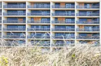  ??  ?? Windows remain boarded up at the Dunes condominiu­ms in Port Aransas nine months after Hurricane Harvey struck. Port Aransas Mayor Charles R. Bujan said almost all the restaurant­s in Port Aransas are open again.