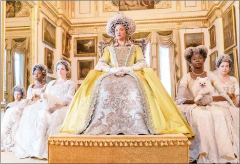  ?? (AP) ?? This image released by Netflix shows Golda Rosheuvel as Queen Charlotte, (center), in the romance series ‘Bridgerton.’ Television producers Shonda Rhimes and Betsy Beers will be honored for their wardrobe efforts on projects like ‘Grey’s Anatomy’ and ‘Bridgerton’ at the Costume Designers Guild Awards.