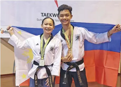  ?? JANICA LIWAG FACEBOOK ?? GOLDEN PAIR. Davao City’s tandem of Elah Janica Liwag and Juan Miguel Dalangin wins the poomsae mixed pair gold medal for Team MindanaoPh­ilippines at the close of the 10th BIMPNT-Eaga Friendship Games taekwondo competitio­n in Brunei Sunday.