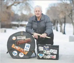  ?? BRANDON HARDER ?? Young kneels with his briefcase and his kick drum case in Wascana Park on Jan. 12.
