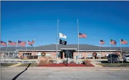  ?? ANTONIO PEREZ/CHICAGO TRIBUNE ?? Some flags fly at half-staff at the Illinois Veterans Home in LaSalle on Friday. The coronaviru­s has killed 30 at the state-run home.