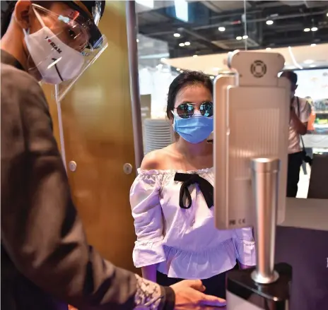 ?? AFP ?? A woman is scanned by facial recognitio­n technology before entering a mall in Bangkok