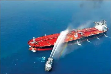  ?? Tasnim News Agency ?? IRAN DENIES it’s behind recent attacks on oil tankers in the Gulf of Oman, as the U.S. claims. This photo reportedly shows an Iranian navy boat fighting a fire on the Norwegian tanker Front Altair after one strike.