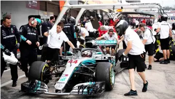  ??  ?? Lewis Hamilton makes a pit stop during a practice session for the Formula One Japanese Grand Prix at Suzuka. — AFP photo