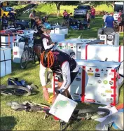  ?? Photo by Jane Bryndel ?? Participan­ts in the Endless Race pack up their bikes at Lazy River Canoe in Ridgway before transition­ing to canoes on Friday morning.