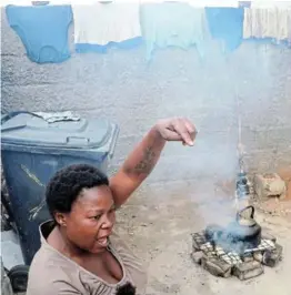  ??  ?? Nthabiseng Matsimela of White City in Soweto boiling water to bath her daughter and also to make tea.