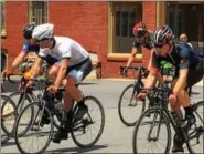  ?? ERIC DEVLIN — DIGITAL FIRST MEDIA ?? Cyclists competing in the Pottstown Bike Race whipped around a 0.9 mile course for several laps Sunday as neighbors cheered from the sidewalks.