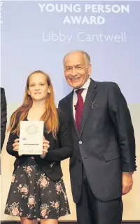  ??  ?? ●●Libby Cantwell receives her RSPCA award from ITV newsreader Alistair Stewart