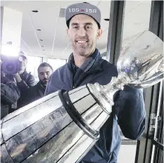  ??  ?? Argonauts quarterbac­k Ricky Ray shows off the Grey Cup on Monday.