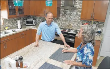  ?? Marta Lavandier The Associated Press ?? Mark Bendell and his wife Laurie talk in their kitchen Monday in Boca Raton, Fla. A stock market slump this year is worrying Americans who are close to retirement.