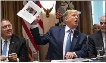  ?? DOUG MILLS — THE NEW YORK TIMES ?? President Donald Trump holds up a photo of Rep. Ilhan Omar during a meeting at the White House in Washington on Tuesday.