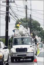  ?? Carol Kaliff / For Hearst Connecticu­t Media ?? Power company crews work in Danbury on Sunday to restore power to residents affected by Tropical Storm Henri.