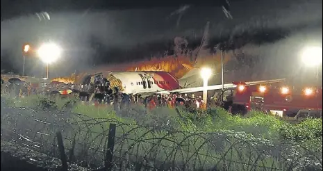  ??  ?? Rescue workers near the crash site after an Air India Express plane skidded off the runway while attempting a landing at the airport in Kerala’s Kozhikode on Friday. >>P4