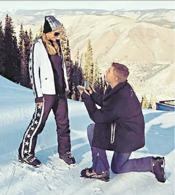  ??  ?? Stars and hypes: Chris Zylka proposes to Paris Hilton on a ski slope in Aspen, Colorado. Romantic but a tad matchy-matchy?