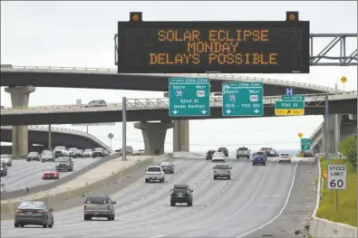  ?? AP Photo ?? Motorists traveling toward Austin, Texas are reminded of today’s eclipse and the possibilit­y of traffic delays Saturday in Austin. Small town businesses are embracing the eclipse crowds, as weekend festivitie­s heat up before today’s big event.