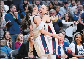  ?? JESSICA HILL/AP PHOTO ?? UConn guard Nika Muhl, left, and UConn guard Paige Bueckers, right, embrace during the second half of Monday’s Big East Conference tournament final against Georgetown.