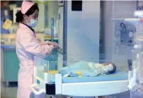  ?? AFP ?? A nurse checks on a baby in a hospital in Xichang, southwest China’s Sichuan province. —