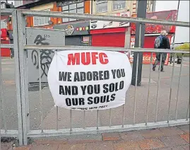  ?? AFP ?? A banner against the proposed Super League hangs from railings of the Manchester United's Old Trafford stadium. The proposed Super League flopped after all six English clubs withdrew.