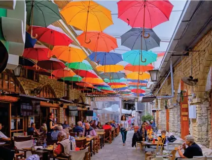  ?? ?? Brolly good show: Plenty of umbrellas at the ready on an old town street in Limassol, Cyprus