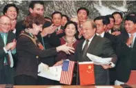 ?? XU JINGXING / CHINA DAILY ?? US Trade Representa­tive Charlene Barshefsky (left) exchanges documents with Chinese Trade Minister Shi Guangsheng after signing a landmark agreement in Beijing in November 1999. The deal paved the way for China’s entry into the WTO.