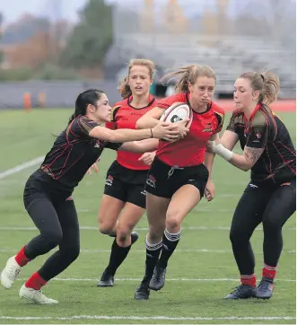  ??  ?? The Laval Rouge et Or (in red) scored a pair of penalty kicks late to down the University of Calgary Dinos 28-22 in quarter-final play at the U Sports women’s national rugby championsh­ip Thursday in Wolfville, N.S.