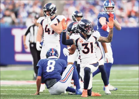  ?? Alex Trautwig / Getty Images ?? The Broncos’ Justin Simmons (31) reacts after tackling Giants quarterbac­k Daniel Jones during the fourth quarter on Sunday.