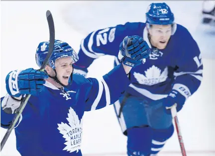  ?? TYLER ANDERSON ?? Toronto Maple Leafs defenceman Martin Marincin, left, celebrates a goal against the Washington Capitals during Game 3 of their playoff series in Toronto on Monday. The Leafs won 4-3 after centre Tyler Bozak scored a minute and a half into overtime, and...