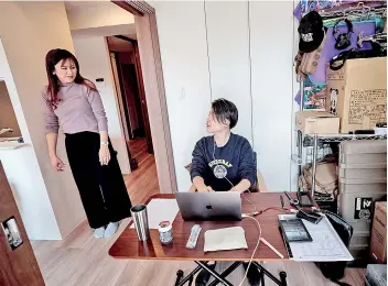  ??  ?? Sato chats with Hitomi (left) while working from home as a result of the Covid-19 novel coronaviru­s, in Tokyo.