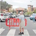  ?? Picture: AP. ?? A hotel bystander behind a security fence.