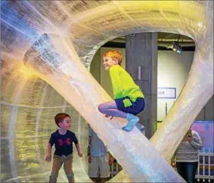  ?? ANITA ORENICK — GREAT LAKES SCIENCE CENTER ?? Children explore the new TapeScape at Great Lakes Science Center.