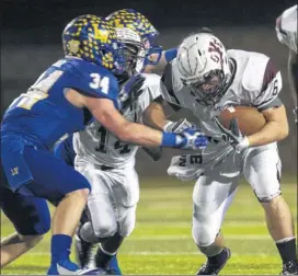  ??  ?? Cameron Yoe running back Keaton Denio (right) is met by Brad Hood (34) of Lago Vista during the first quarte Friday night.