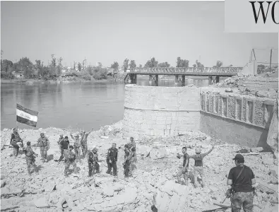  ?? FELIPE DANA / THE ASSOCIATED PRESS ?? Iraqi Special Forces soldiers celebrate on Sunday after reaching the western bank of the Tigris River. Counter-terrorism forces have spent nine months fighting ISIL militants to recapture Mosul.