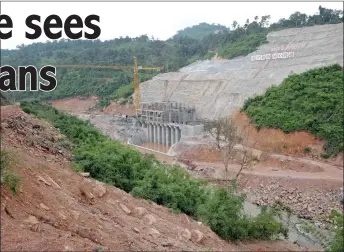  ?? — AFP file photo ?? Workers are seen buiding a hydroelect­ric dam along a river in the Cardamom Mountains in Koh Kong province