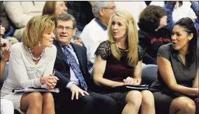  ?? Fred Beckham / Associated Press ?? UConn coach Geno Auriemma shares a light moment with associate head basketball coach Chris Dailey, left, and assistant coaches Shea Ralph, second from right, and Marisa Moseley in 2014.