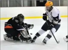  ?? Photo by John Gleeson ?? Jared Hershman (R) pressures Cherokee goalie for the Golden Hawks.