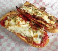  ?? Democrat-Gazette file photo ?? Now that Bruno’s Little Deli has moved into the main restaurant, only the deli’s French-bread pizza, not the Neapolitan-style pie that made Bruno’s Little Italy famous, will be available for lunch.