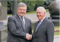  ?? EFREM LUKATSKY/THE ASSOCIATED PRESS ?? U.S. Secretary of State Rex Tillerson, right, is in Ukraine to reaffirm American support with President Petro Poroshenko, left, as the country struggles with a Russia-backed insurgency in the east.