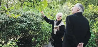  ?? MORGAN CROSS ?? Konstantin­e Kavtaradze, ambassador of Georgia to Canada, gets a tour of Abkhazi Garden from Land Conservanc­y of B.C. executive director Cathy Armstrong.