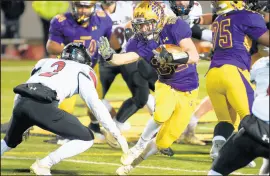  ??  ?? Hobart running back DJ Lipke fends off Lowell defensive back John Alessia III.