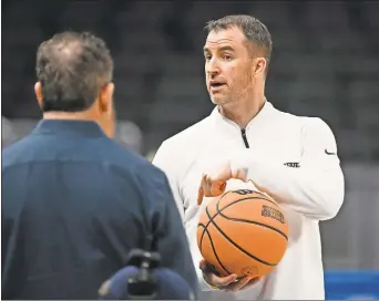  ?? Robert Goddin/USA TODAY Sports ?? Utah State Aggies head coach Danny Sprinkle is seen during the NCAA tournament practice day at Gainbridge FieldHouse. Sprinkle has been named the new head basketball coach at Washington University.