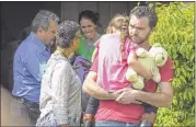  ??  ?? ASSOCIATED PRESS FILES Rusty Page carries Lexi while Summer Page (in background) cries as family services workers (left) arrived on March 21 to take Lexi away from her foster family in Santa Clarita, Calif.