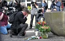  ?? AP PHOTO ?? A man brings flowers Sunday to the place in Muenster, Germany where a vehicle crashed into a crowd Saturday.