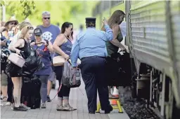  ?? CHARLIE RIEDEL/AP, FILE ?? Passengers board a Missouri River Runner Amtrak train in Lee’s Summit, Mo. The state now leads the nation with the highest rate of new COVID-19 infections.