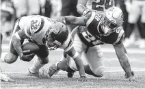  ?? Brett Coomer / Staff photograph­er ?? Texans defensive back Tyrann Mathieu, left, intercepts a pass intended for Patriots RB James White in the first quarter.