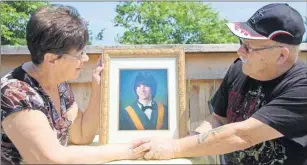  ?? ANCELENE MACKINNON/TC MEDIA ?? Nancy and Clifford Desroches hold the graduation photo of their grandson, Dylan Champion, who died at 21 after attending a music festival in Nova Scotia.