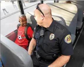  ?? PETE BANNAN — DIGITAL FIRST MEDIA ?? Mary C. Howse Elementary second-grade student Sammuel Morris, 7, speaks with West Whiteland Police Detective Jeff McCloskey, who rode the school bus Wednesday to speak to the children about school bus safety as part of Operation “Safe Stop.”