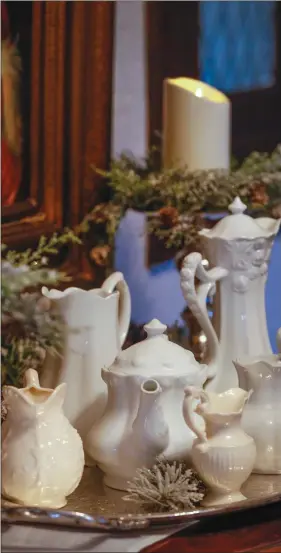  ??  ?? A sampling from a collection of white pitchers add snowy white and winter white to a silver and white display in a hall entry. Placing items on a tray makes a display look more complete. (Fernando Salazar/TNS)